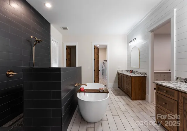 a bathroom with a granite countertop sink mirror vanity and toilet