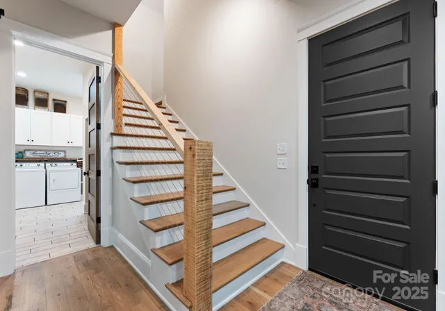 a view of entryway and hall with wooden floor