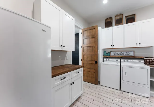 a kitchen with white cabinets and white appliances