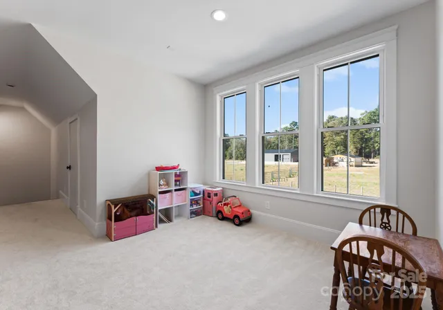 a living room with furniture and windows