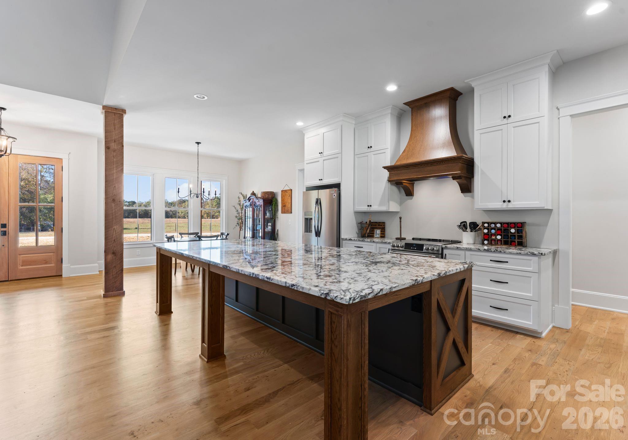 3760 Cappadocia Church Road Polkton, NC 28135 - Photo 4 of 48 a kitchen with stainless steel appliances granite countertop a stove and a wooden floors