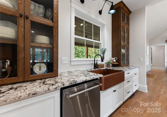 a kitchen with granite countertop a sink and a stove