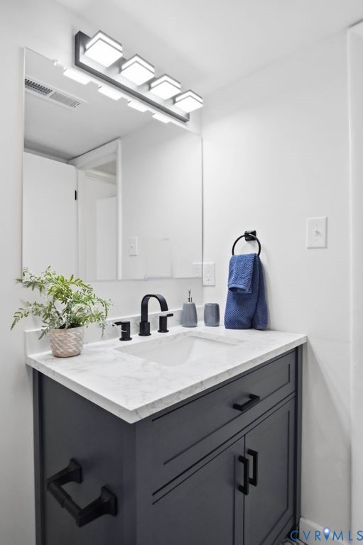 10270 Iron Mill Road Richmond, VA 23235 - Photo 19 of 29 Bathroom vanity featuring a white marble-patterned