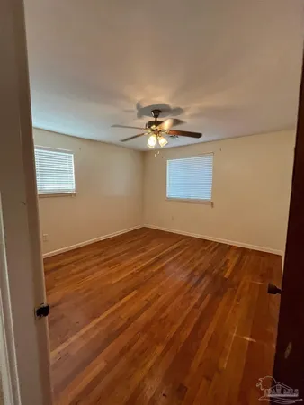 a view of a room with wooden floor