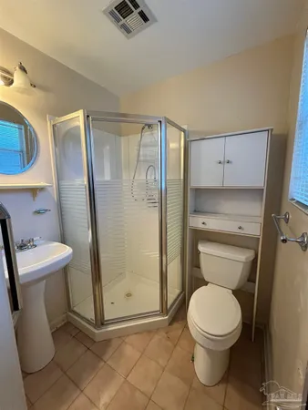 a bathroom with a toilet and a shower