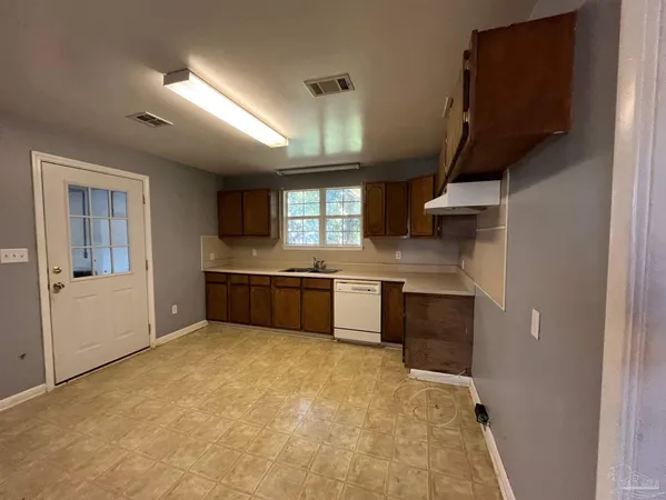 a kitchen with stainless steel appliances a sink stove and cabinets