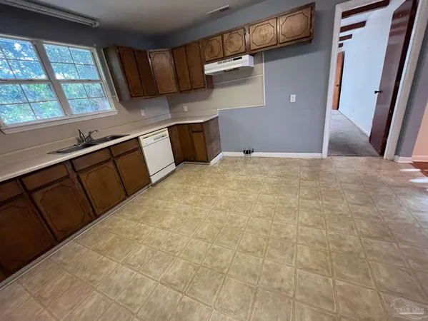 a view of a kitchen with a sink and a window