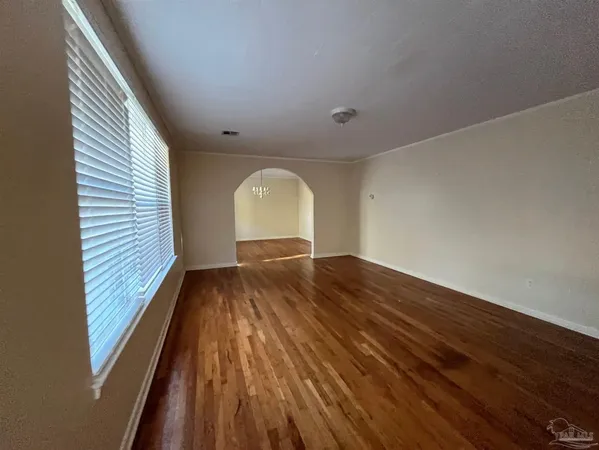 a view of room with window and wooden floor