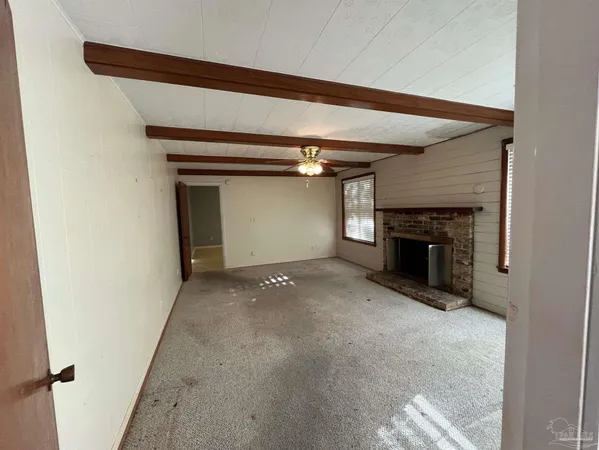 a view of empty room with a fireplace