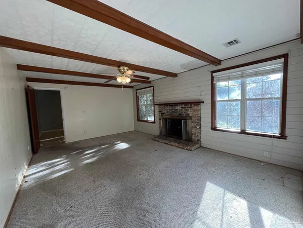 a view of empty room with a fireplace