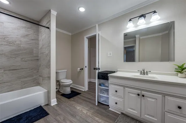 a spacious bathroom with a double vanity sink a large mirror and a bathtub