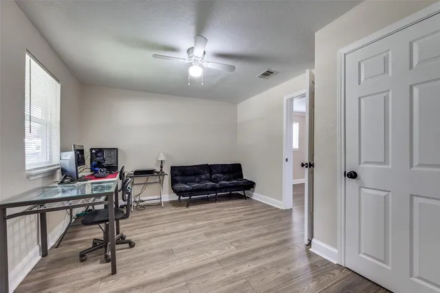 a view of a workspace with furniture and wooden floor