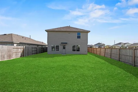 a view of a house with backyard and a garden