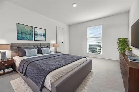 a bedroom with bed and a window
