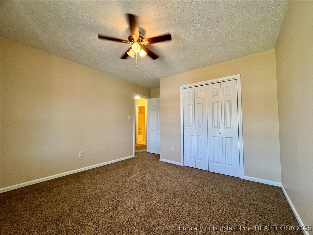127 Nantahala Drive Linden, NC 28356 - Photo 17 of 22 an empty room with a chandelier fan and windows