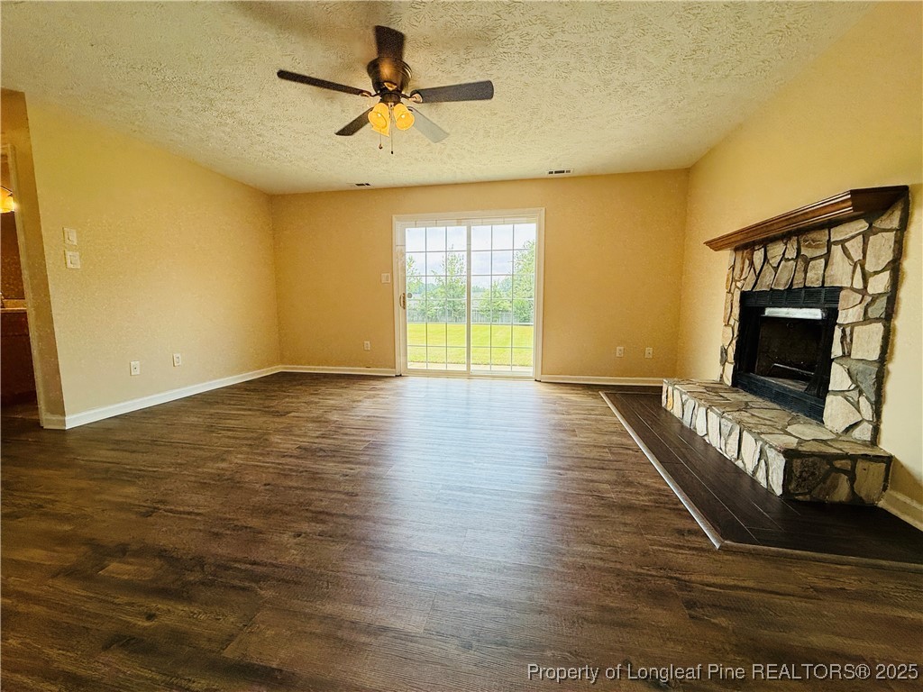 127 Nantahala Drive Linden, NC 28356 - Photo 20 of 22 a view of an empty room with wooden floor and a fireplace