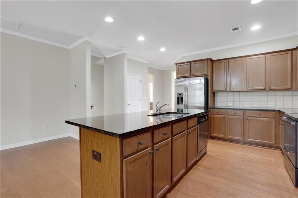 1300 Hopkins Drive Decatur, GA 30033 - Photo 6 of 30 a kitchen with stainless steel appliances granite countertop a sink and cabinets