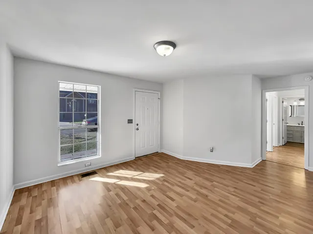 wooden floor in an empty room with a window