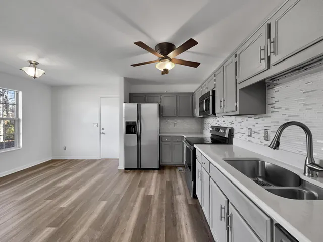 a kitchen with stainless steel appliances a refrigerator sink and cabinets
