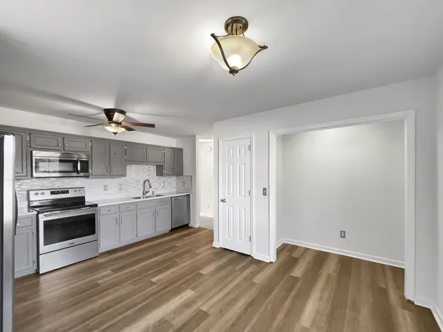 a view of a kitchen with a sink dishwasher and a refrigerator