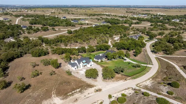 an aerial view of a house with a yard