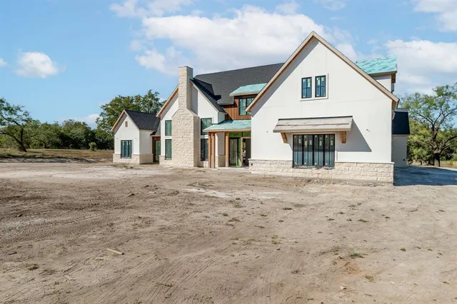 a view of a house with a wooden deck