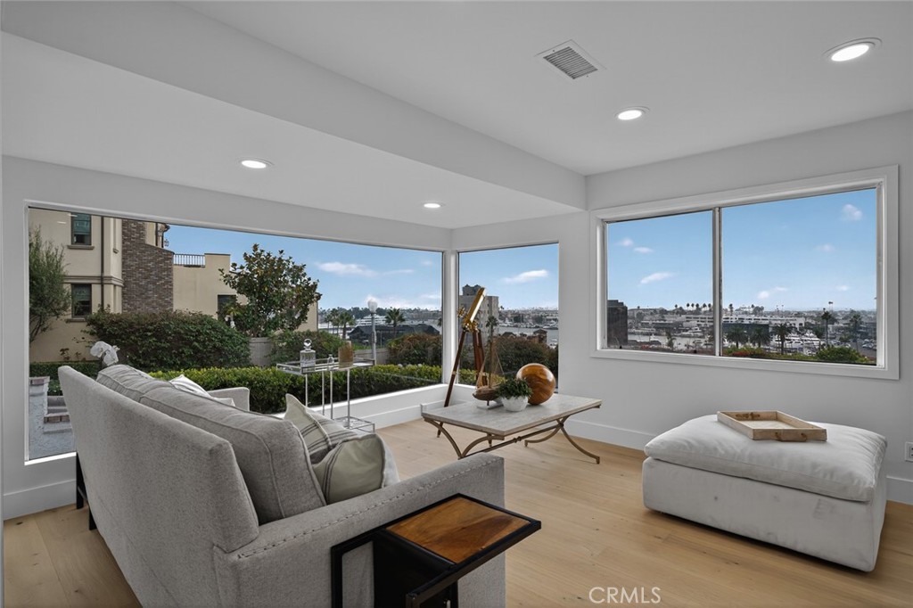 a living room with furniture and a floor to ceiling window