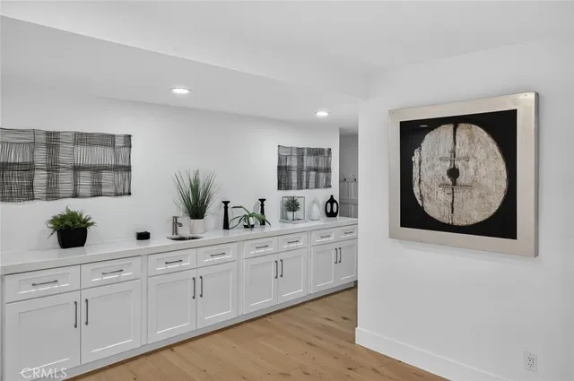 a view of cabinets wooden floor and windows
