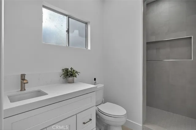 a bathroom with a sink toilet and a mirror