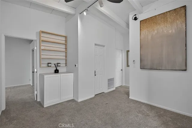 a kitchen with white cabinets and white appliances
