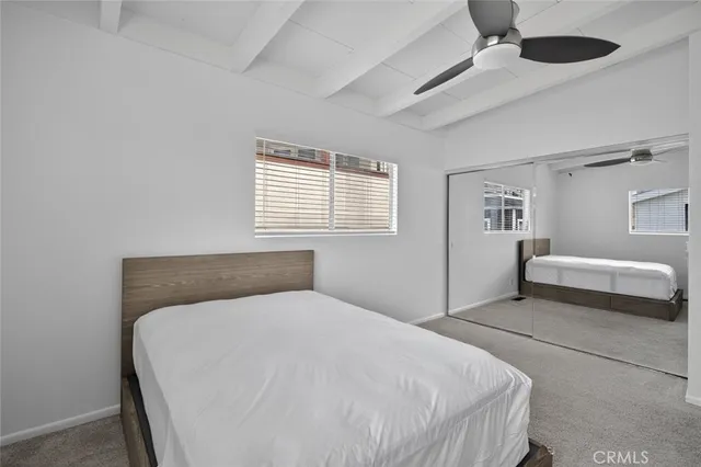 a bedroom with a bed and window