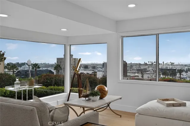 a living room with furniture and a floor to ceiling window