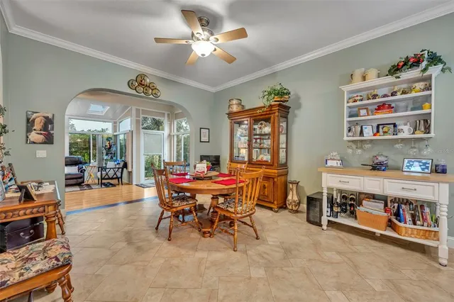 a view of a dining room with furniture and chandelier