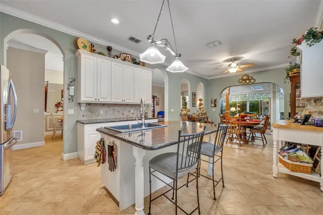 a kitchen with stainless steel appliances granite countertop a stove oven and a refrigerator with cabinets