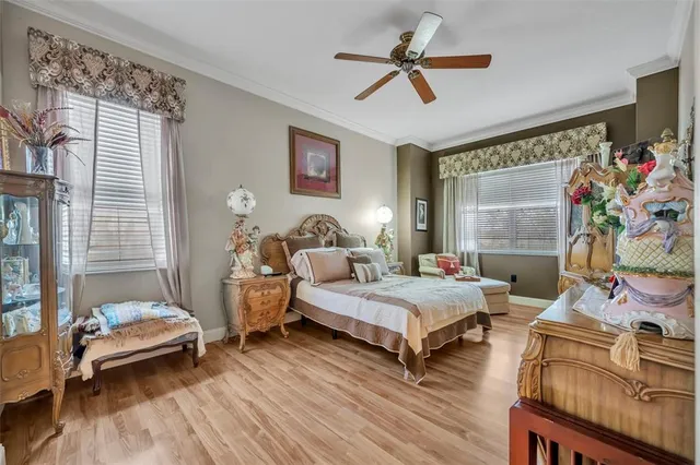 a bedroom with two beds and a large window