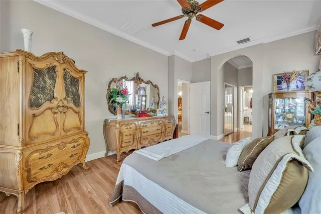 a bedroom with furniture and wooden floor