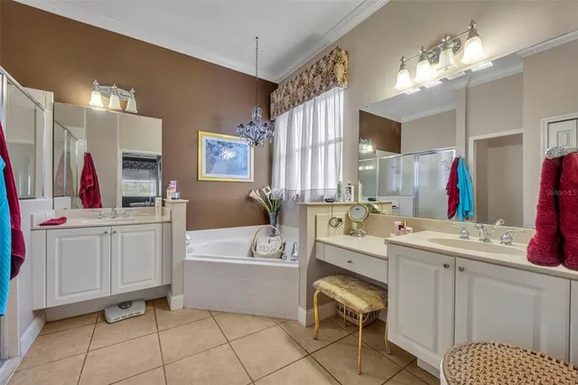 a bathroom with a sink vanity tub and shower