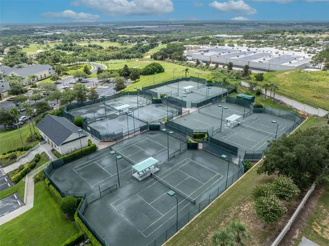 an aerial view of a house with a yard and lake view