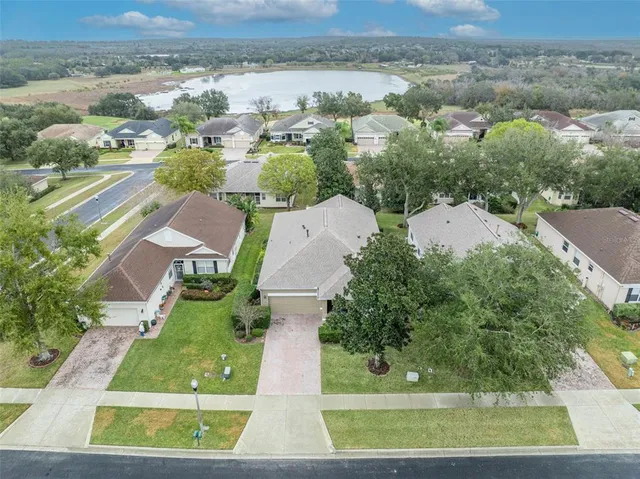 an aerial view of house with yard swimming pool and ocean view