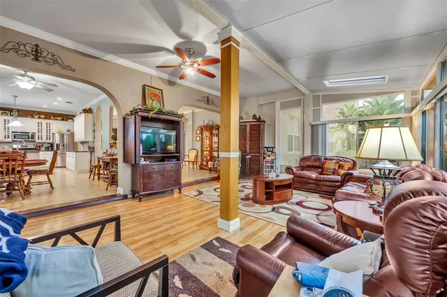 a living room with lots of furniture and a large window