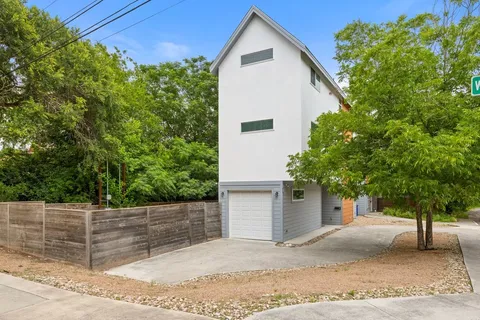 a view of a house with a yard and garage