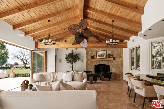 a front view of a house with a garden and deck