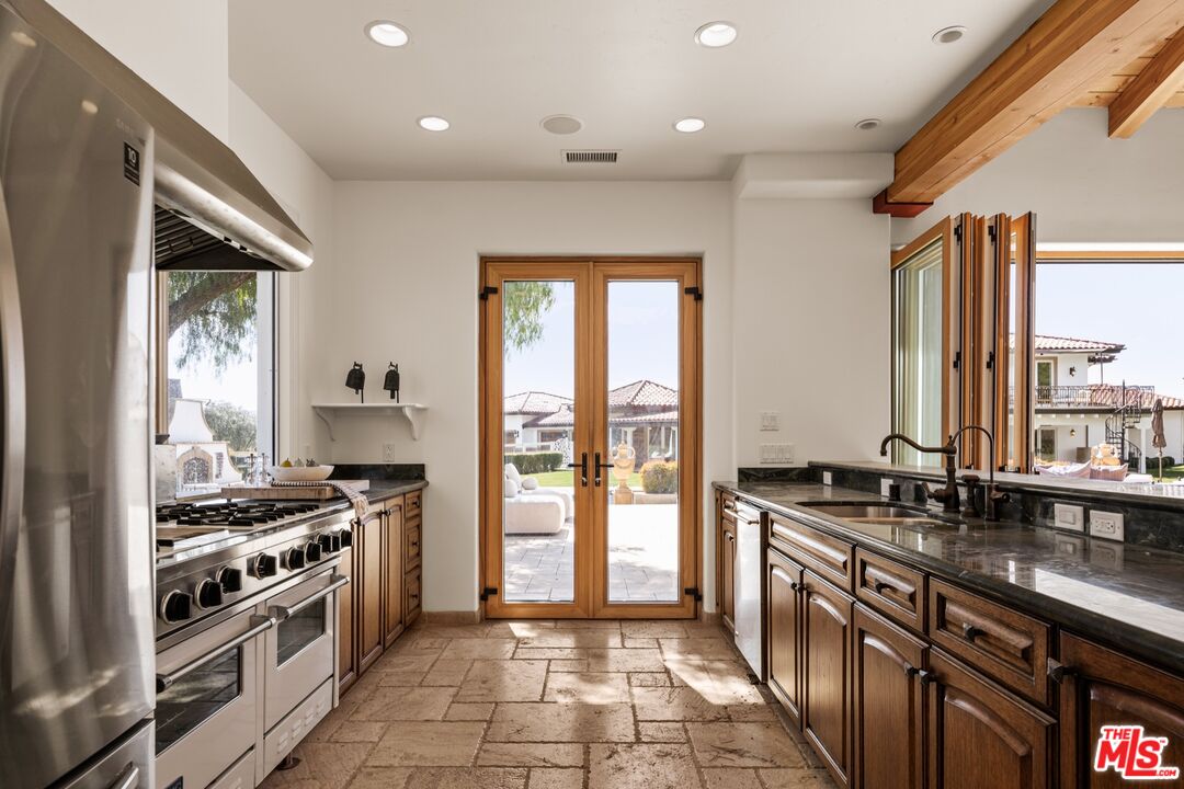 2370 North Refugio Road Santa Ynez, CA 93460 - Photo 39 of 66 a kitchen with stainless steel appliances granite countertop a stove a sink and a refrigerator