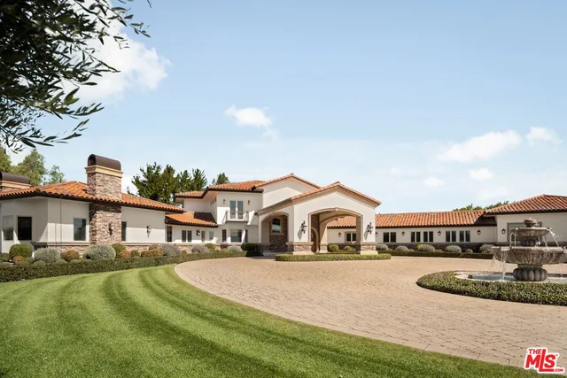 a view of entryway with a grandfather clock and wooden floor