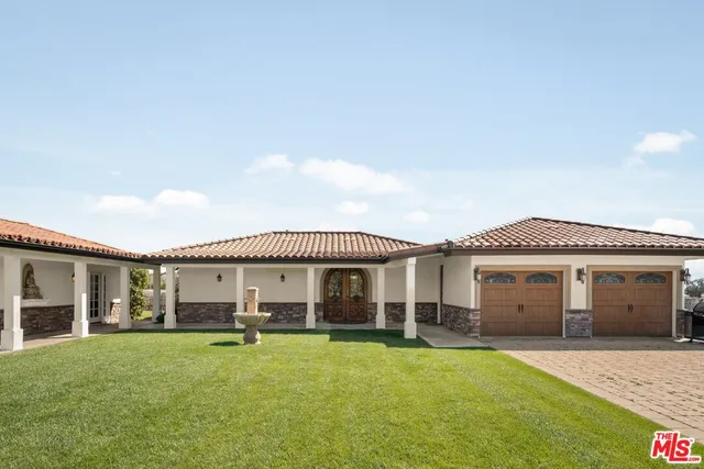 a view of a patio with a table chairs and garden
