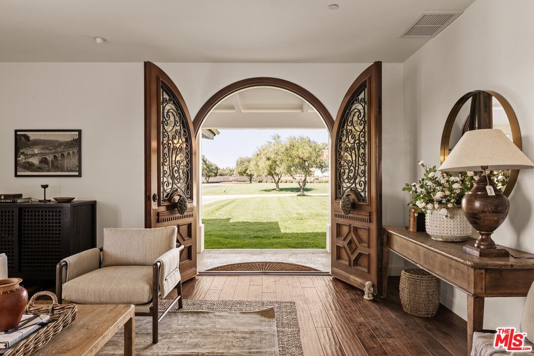 2370 North Refugio Road Santa Ynez, CA 93460 - Photo 44 of 66 a living room with furniture and a floor to ceiling window