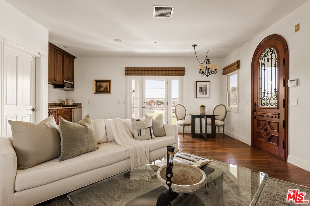 2370 North Refugio Road Santa Ynez, CA 93460 - Photo 46 of 66 a living room with furniture a fireplace and a flat screen tv