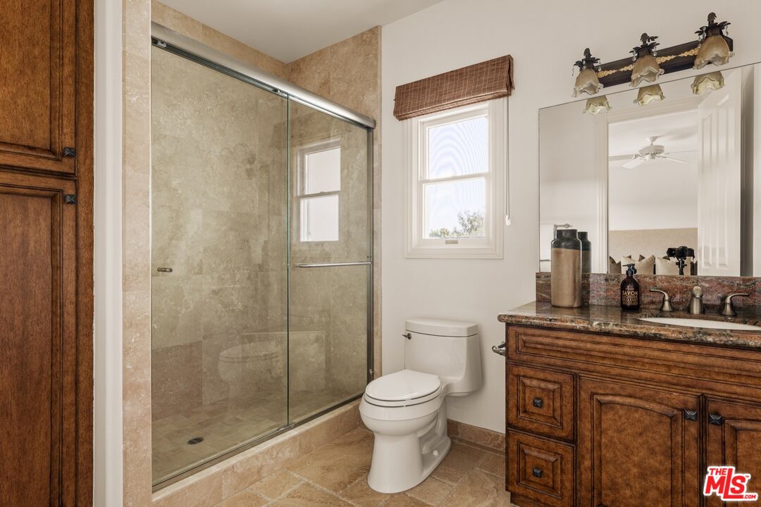 2370 North Refugio Road Santa Ynez, CA 93460 - Photo 48 of 66 a bathroom with a toilet a sink and a mirror