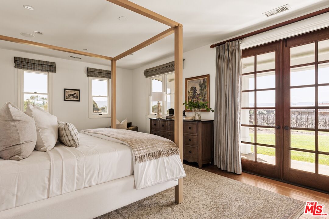 2370 North Refugio Road Santa Ynez, CA 93460 - Photo 50 of 66 a bedroom with a large bed and a large window