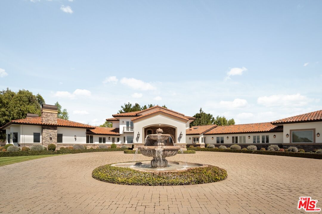 2370 North Refugio Road Santa Ynez, CA 93460 - Photo 5 of 66 a white house with a large pool and lawn chairs